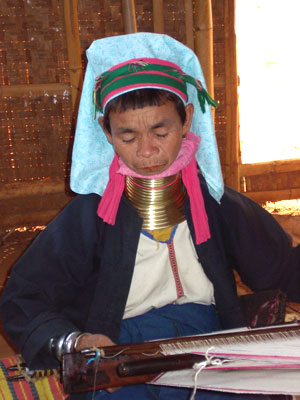 In Myanmar (Burma), a tribal lady weaves cloth.